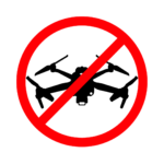 A silhouette icon of a drone has a large red circle with a line through it over it indicating no drone zone