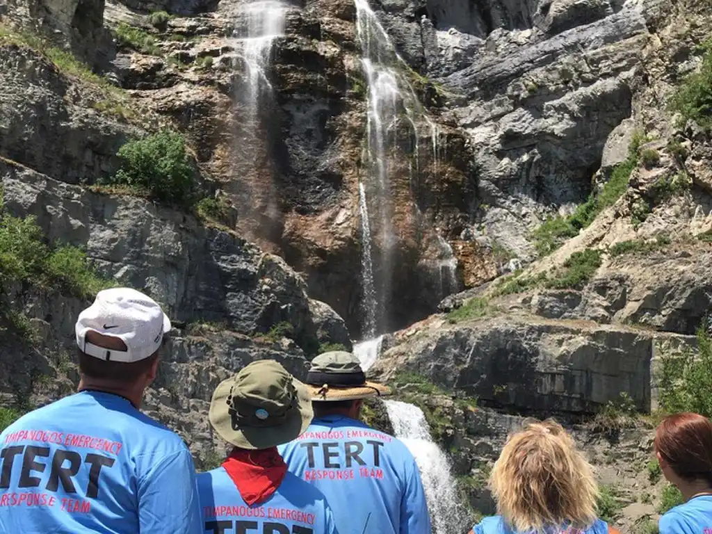 Five TERT members are not facing the camera and looking at Stewart Falls