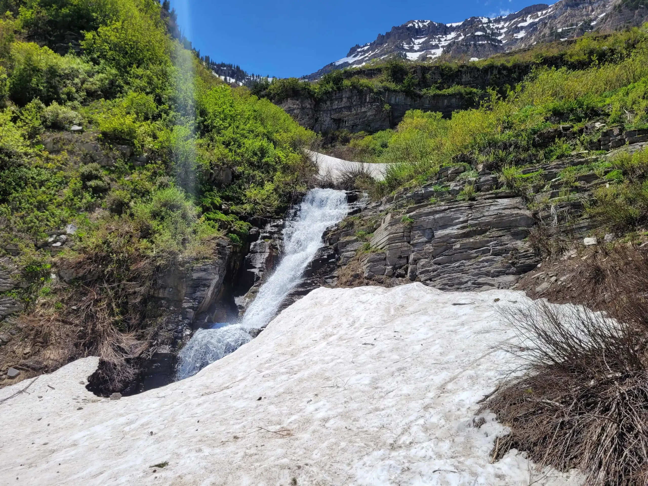 A waterfall is shown with snow over it